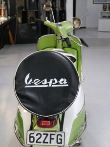 Back view of mint green Vespa Scooter